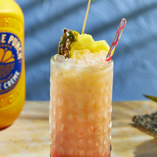 The Sandstrom cocktail Sunshine garnished with pineapple wedge